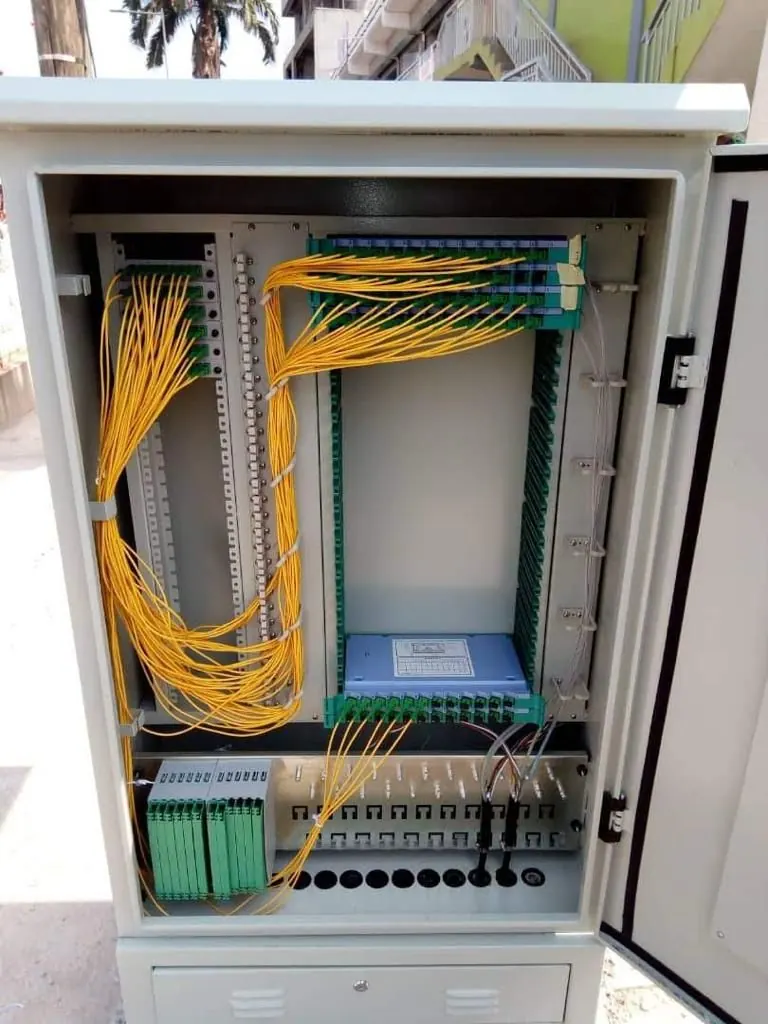 Optical distribution frame with yellow patch cords inside a street cabinet
