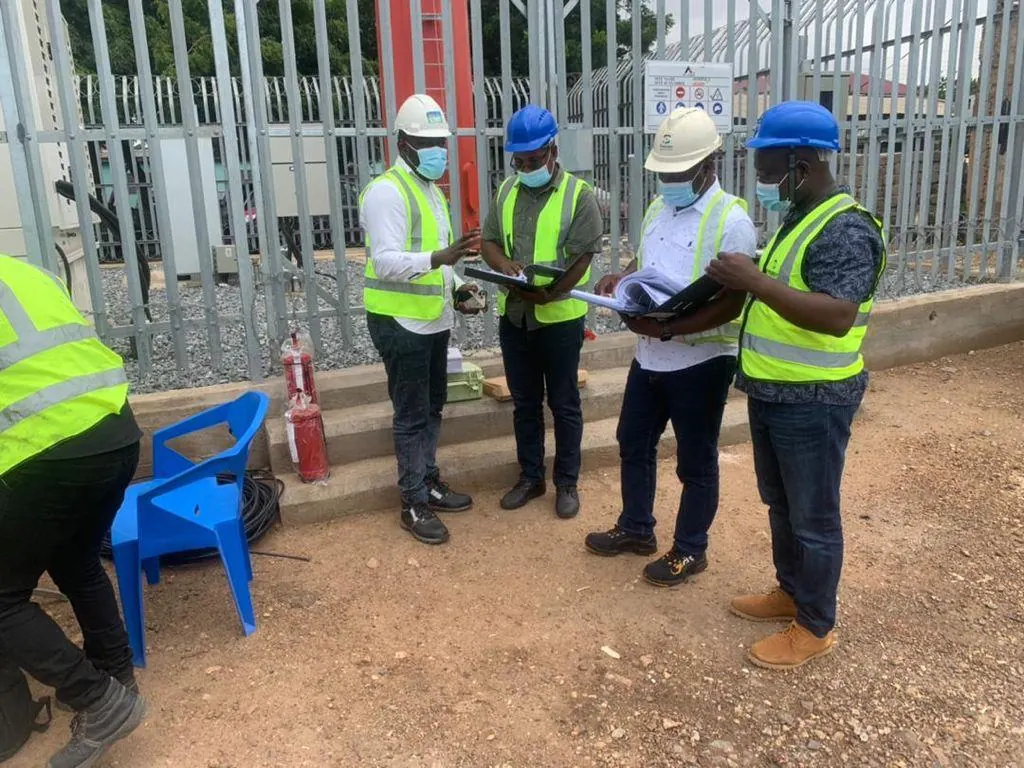 Crew assembled around equipment during the site tour