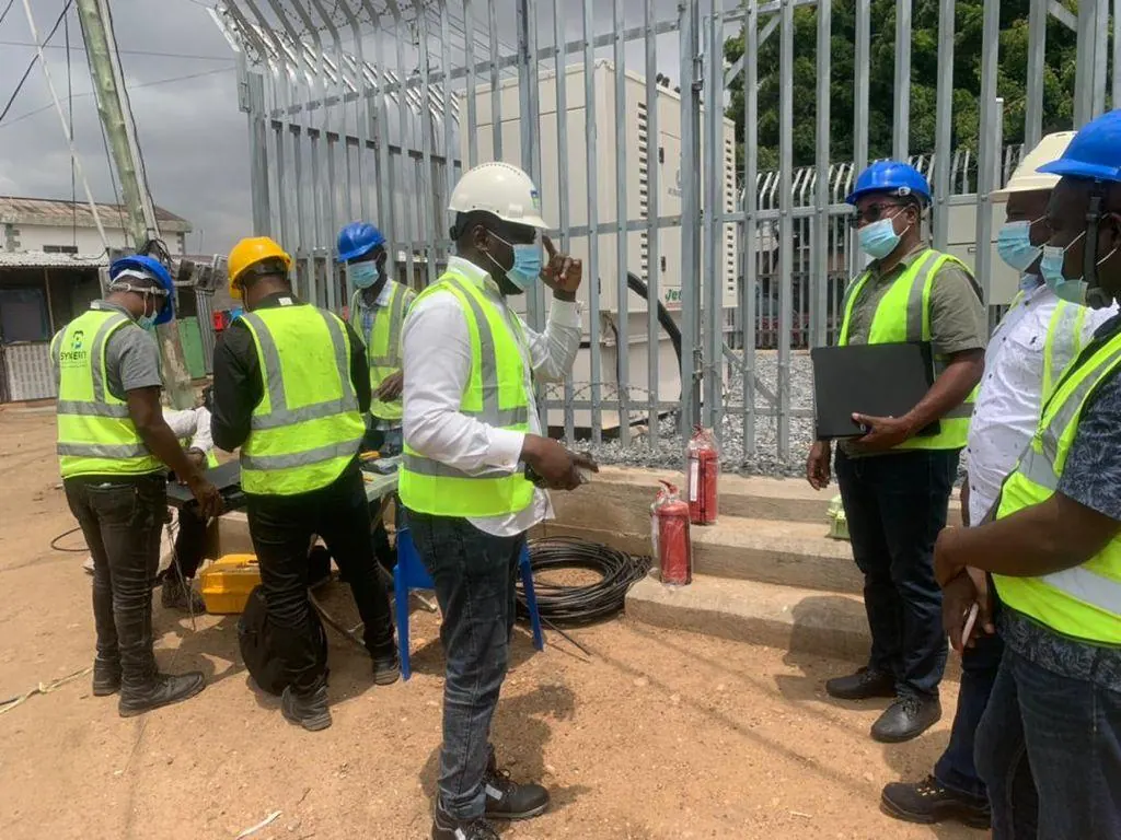 Team gathered around a cable drum and site equipment