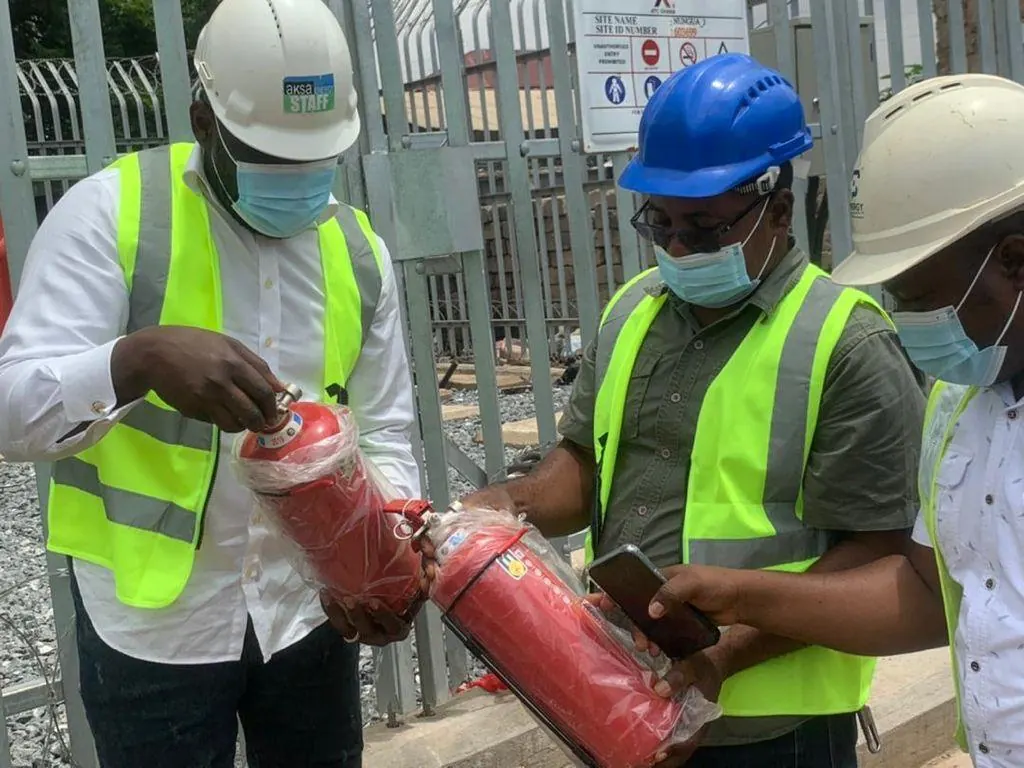 Fire extinguisher training with staff observing