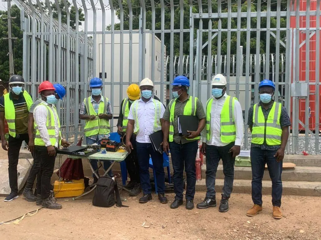 Wide view of the team with equipment laid out for inspection