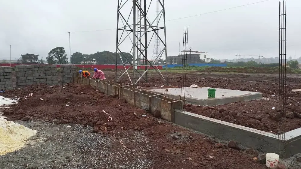 Equipment slab and foundation beams cast at the base of a lattice tower