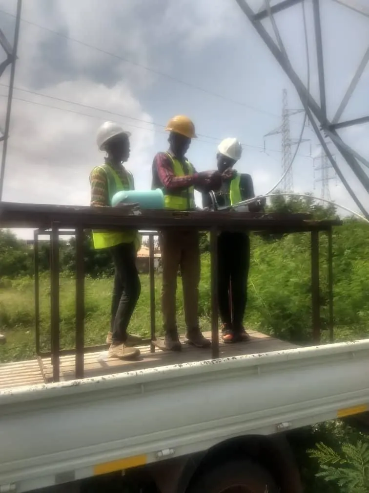 Two SPA workers installing cable on an elevated structure